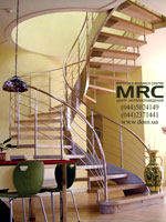 Spiral staircase on bow-string. Baluster of staircase from polished stainless steel, stages from hard breeds of tree