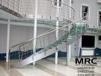 Metalic curvilinear staircase on bow-strings. Framework and baluster staircase from polished stainless steel, 
stages from safe architectural glass