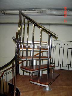 part of spiral staircase with oak stages and with baluster from polished stainless steel