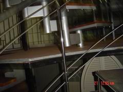 baluster from polished stainless steel of staircase with wood stages