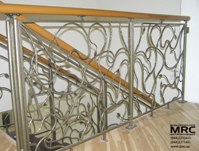 Polymeric handrailing on the forged baluster