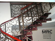 Forged baluster and polymeric handrailing of one stepped string staircase