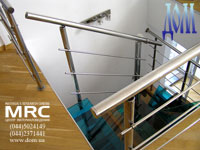 Baluster from polished stainless steel and illumination (on the wall) of staircase in apartment