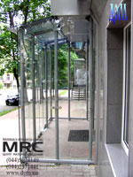 Glass entrance lobby consists metalic framework, glass door and glass walls